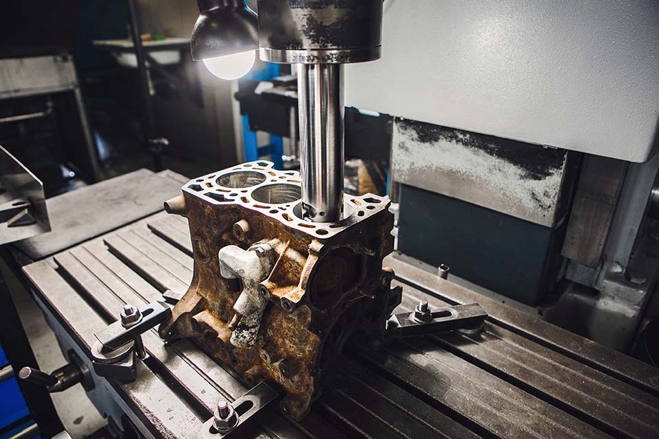 Engine cylinder boring on cnc machine. Boring under the piston after engine sleeve using machine with Computer Numerical Control.